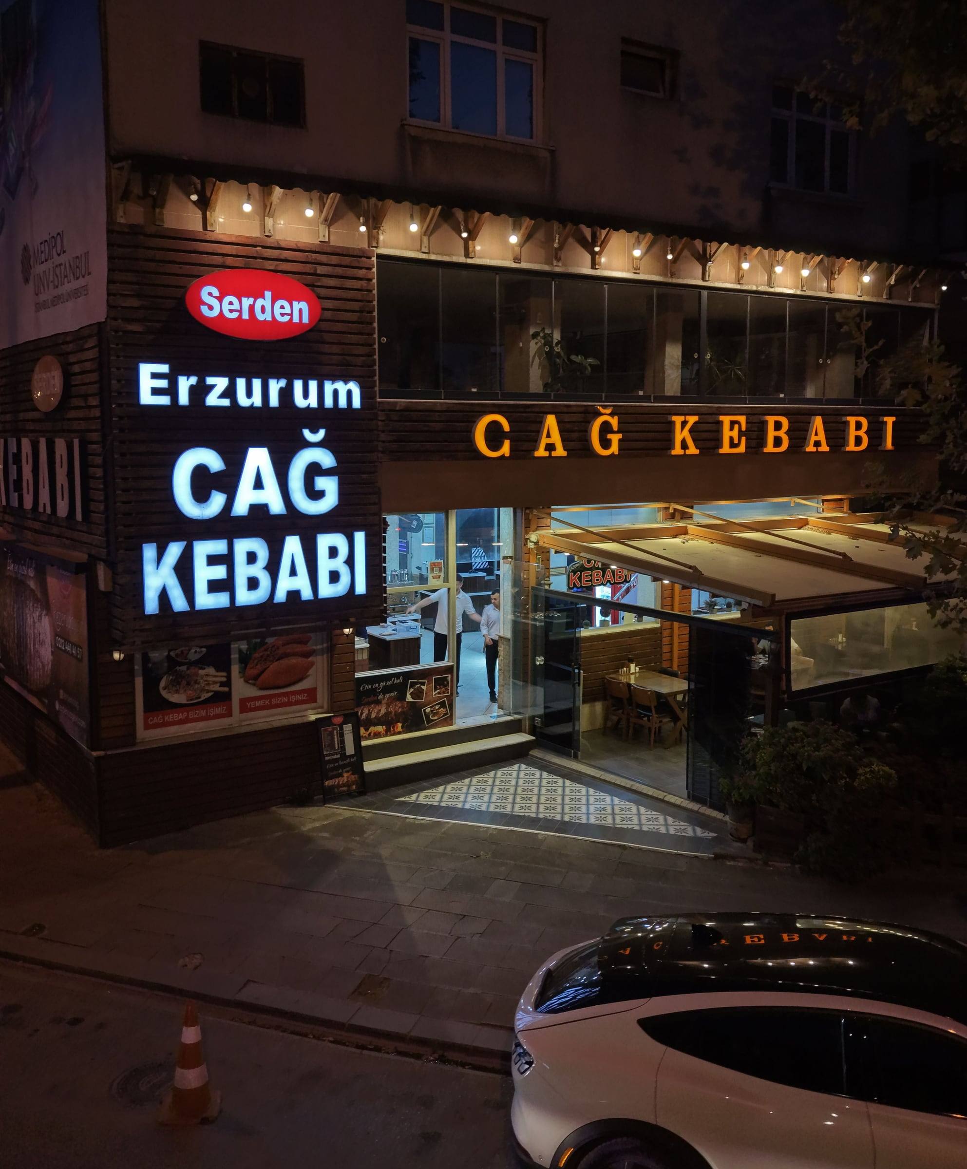 Serden’s sign and front garden at night, on Dereboyu Avenue